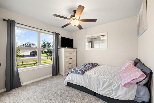 9117 NW 123rd St, Yukon, OK 73099 - bedroom featuring light carpet, baseboards, multiple windows, and a ceiling fan