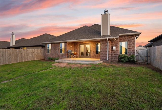9117 NW 123rd St, Yukon, OK 73099 - rear view of property featuring a patio area, brick siding, a chimney, and a shingled roof