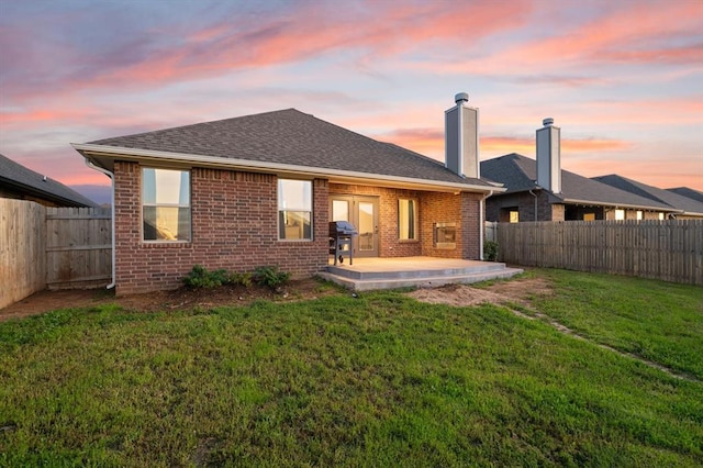 9117 NW 123rd St, Yukon, OK 73099 - back of house featuring a patio, brick siding, a chimney, and a shingled roof