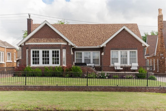 view of front of house featuring a chimney, brick siding, and roof with shingles