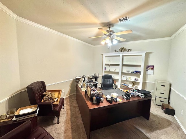 carpeted office space featuring a ceiling fan, ornamental molding, and baseboards
