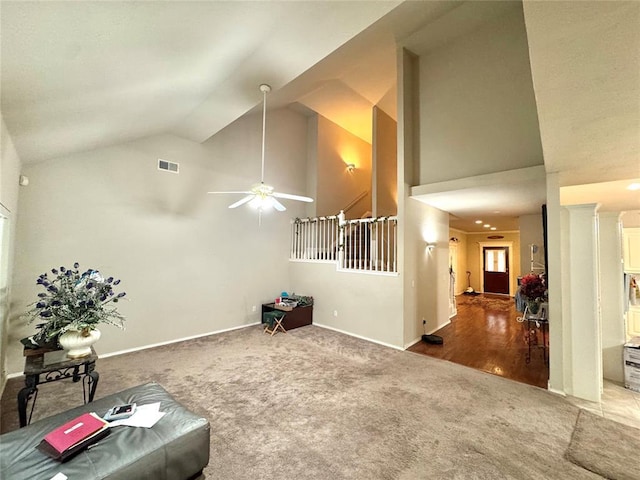 living room with carpet floors, high vaulted ceiling, a ceiling fan, and baseboards