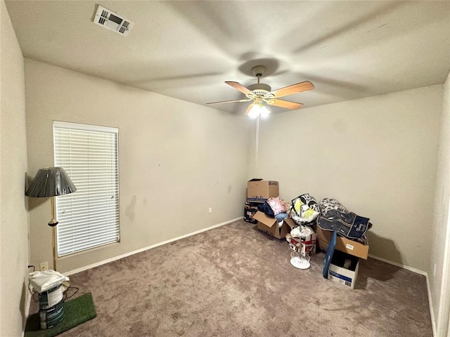 misc room with carpet floors, ceiling fan, and baseboards