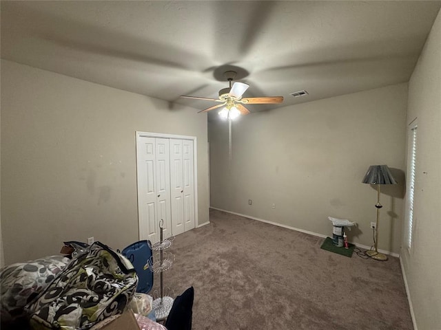 unfurnished bedroom with carpet floors, a closet, ceiling fan, and baseboards