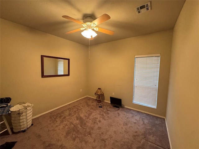 unfurnished room with carpet flooring, ceiling fan, and baseboards