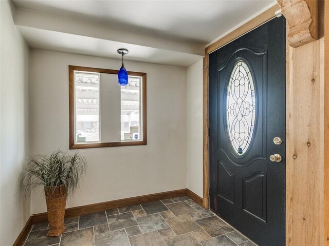 3208 NW 34th St, Oklahoma City, OK 73112 - entryway with baseboards, healthy amount of natural light, and dark stone finish floors