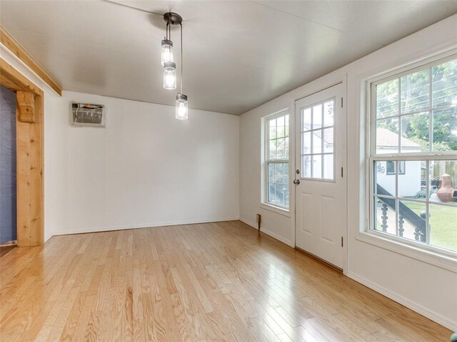 3208 NW 34th St, Oklahoma City, OK 73112 - spare room featuring light wood-style flooring, an AC wall unit, and baseboards