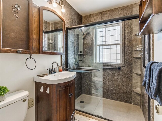 3208 NW 34th St, Oklahoma City, OK 73112 - bathroom with toilet, vanity, a stall shower, and tile patterned floors