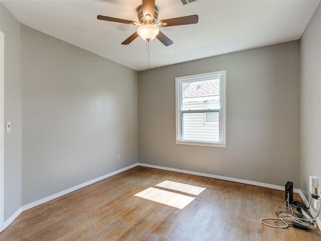 3208 NW 34th St, Oklahoma City, OK 73112 - spare room featuring wood finished floors, baseboards, and a ceiling fan