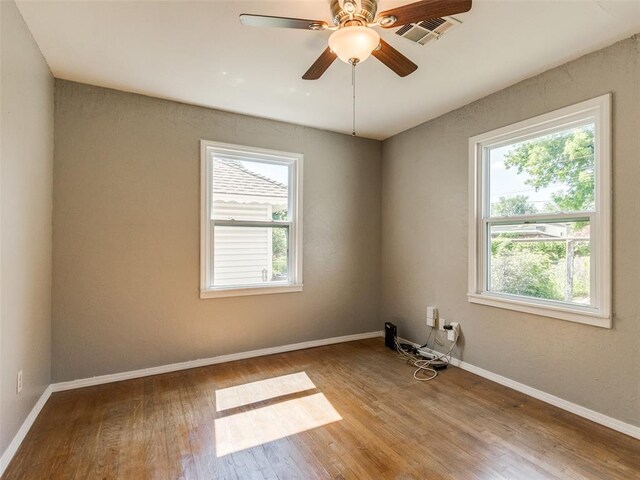 3208 NW 34th St, Oklahoma City, OK 73112 - unfurnished room with healthy amount of natural light, wood-type flooring, baseboards, and a ceiling fan