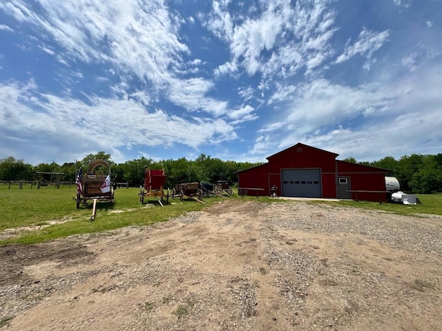 377056 E 1040th Rd, Okemah, OK 74859 - view of green lawn featuring a detached garage, driveway, an outdoor structure, and a pole building
