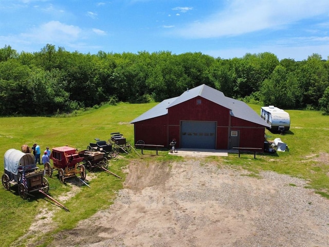 377056 E 1040th Rd, Okemah, OK 74859 - detached garage with dirt driveway and a view of trees