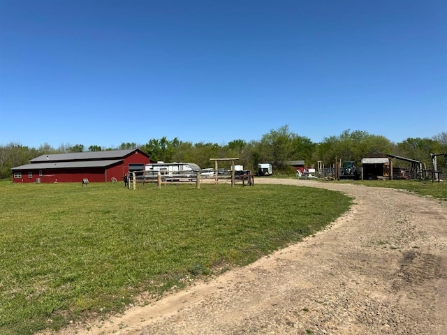 377056 E 1040th Rd, Okemah, OK 74859 - view of green lawn with a pole building, an outdoor structure, and dirt driveway