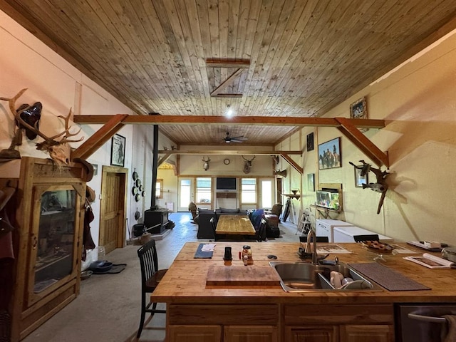 377056 E 1040th Rd, Okemah, OK 74859 - kitchen featuring a sink, butcher block counters, open floor plan, carpet floors, and dishwasher