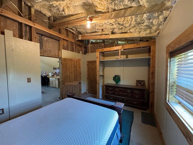 377056 E 1040th Rd, Okemah, OK 74859 - bedroom featuring concrete flooring and a closet