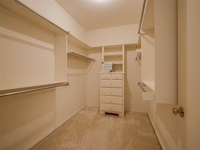 walk in closet featuring light carpet