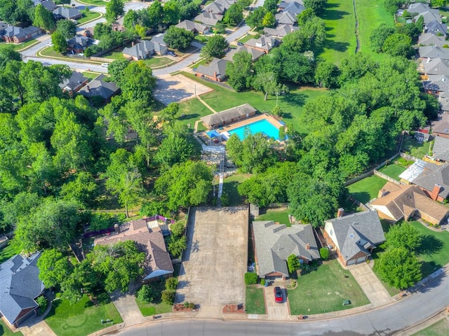 view of property location with nearby suburban area and a pool