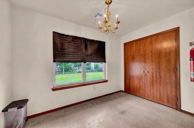 unfurnished bedroom featuring a chandelier, baseboards, and a closet