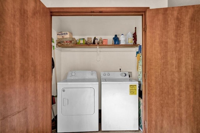 clothes washing area with washer and clothes dryer
