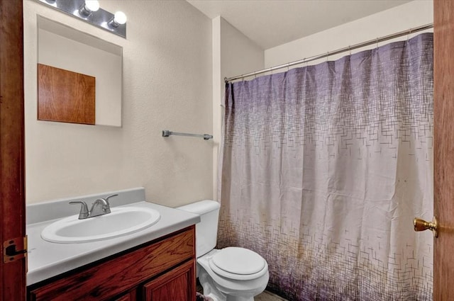 bathroom featuring toilet, vanity, and a shower with shower curtain