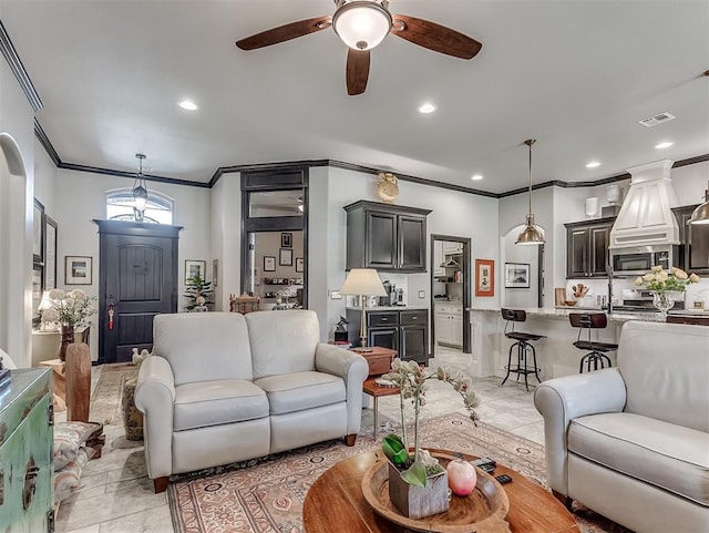 living room featuring crown molding, ceiling fan, light tile patterned floors, and recessed lighting