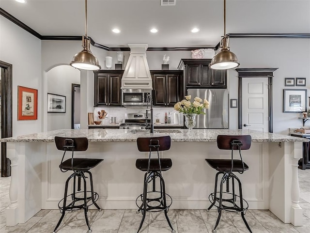 kitchen featuring appliances with stainless steel finishes, ornamental molding, a sink, custom exhaust hood, and a large island