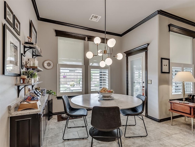dining space featuring ornamental molding, a chandelier, baseboards, and light tile patterned floors