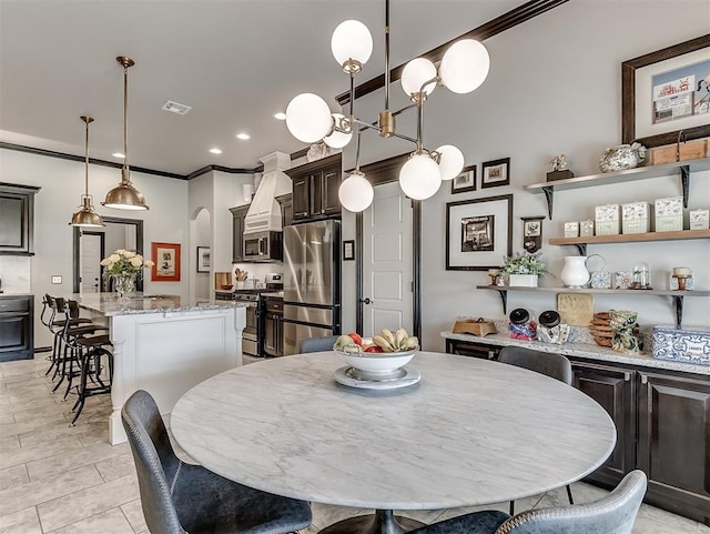 dining area featuring crown molding, arched walkways, and recessed lighting