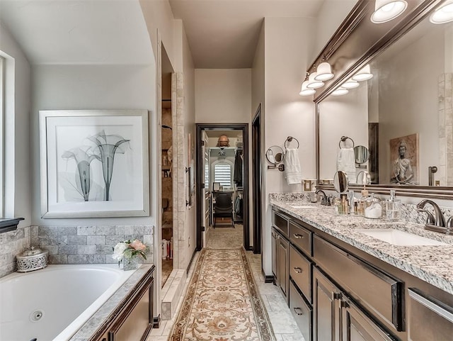 bathroom featuring a tub with jets, double vanity, a shower stall, and tile patterned flooring