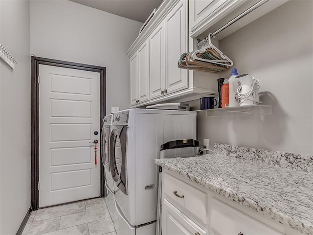 laundry room featuring washer and clothes dryer and cabinet space