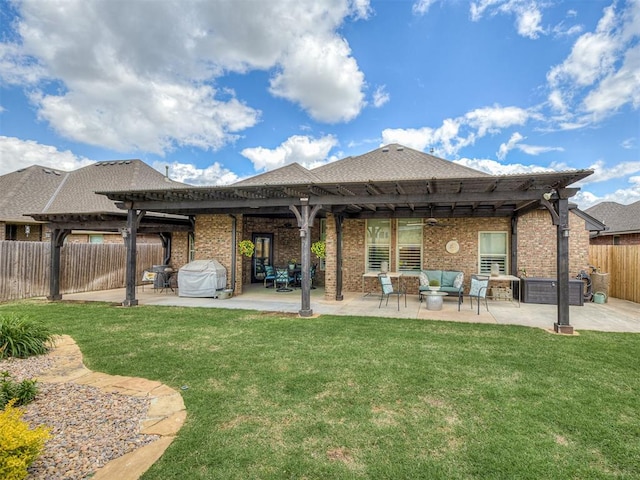 back of property with a pergola, outdoor lounge area, brick siding, and a patio area