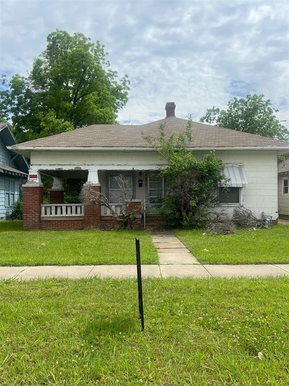 1418 NW 30th St, Oklahoma City, OK 73118 - view of front facade featuring a front lawn, a chimney, and a shingled roof