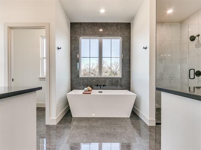 14029 N Ridge Dr, Choctaw, OK 73020 - bathroom featuring a tile shower, marble finish floors, a soaking tub, baseboards, and recessed lighting