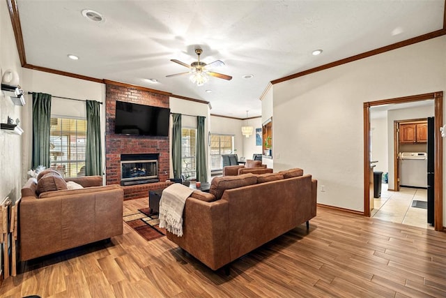 8109 Dawn Cir, Oklahoma City, OK 73135 - living area with ornamental molding, healthy amount of natural light, a ceiling fan, a fireplace, and light wood-style flooring