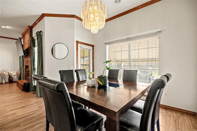 8109 Dawn Cir, Oklahoma City, OK 73135 - dining area with crown molding, a chandelier, light wood finished floors, and baseboards