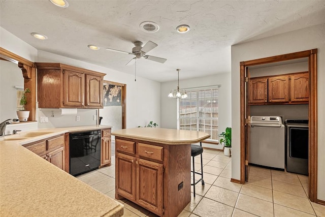8109 Dawn Cir, Oklahoma City, OK 73135 - kitchen featuring black dishwasher, a sink, washer and dryer, a breakfast bar area, and ceiling fan