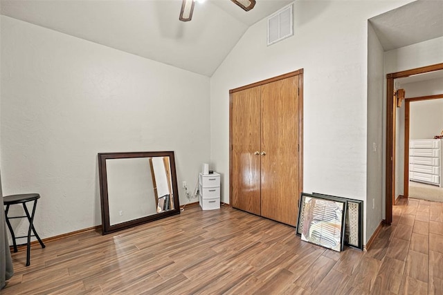 8109 Dawn Cir, Oklahoma City, OK 73135 - unfurnished bedroom with lofted ceiling, wood finished floors, a closet, ceiling fan, and baseboards