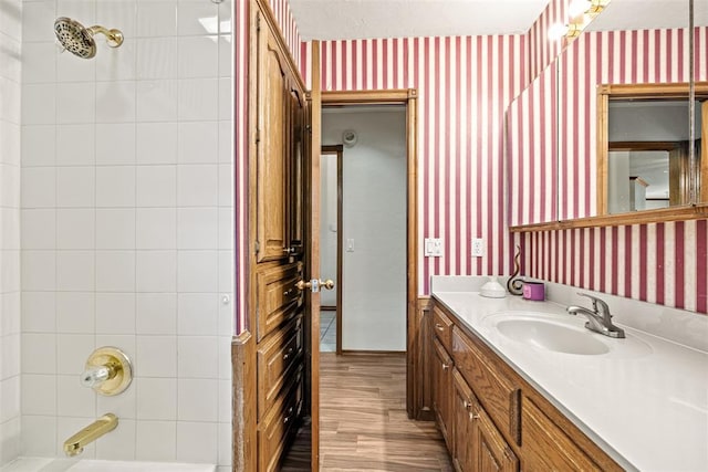 8109 Dawn Cir, Oklahoma City, OK 73135 - bathroom featuring wallpapered walls, vanity, wood finished floors, and washtub / shower combination