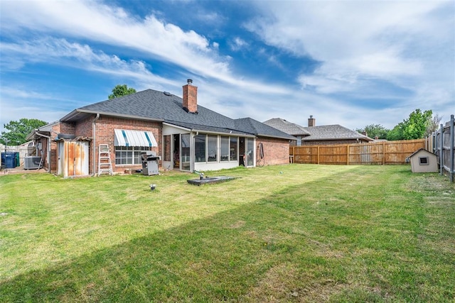 8109 Dawn Cir, Oklahoma City, OK 73135 - back of property with brick siding, a sunroom, cooling unit, a shingled roof, and a chimney