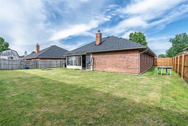 8109 Dawn Cir, Oklahoma City, OK 73135 - rear view of property featuring brick siding, a chimney, roof with shingles, and a sunroom