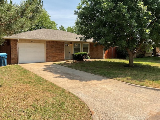 201 Lois Ave, Tuttle, OK 73089 - view of front of property featuring brick siding, an attached garage, driveway, and a front lawn