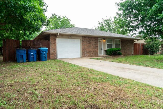 201 Lois Ave, Tuttle, OK 73089 - single story home featuring an attached garage, brick siding, and concrete driveway