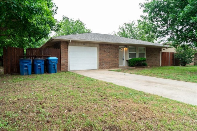 201 Lois Ave, Tuttle, OK 73089 - single story home featuring an attached garage, brick siding, and concrete driveway