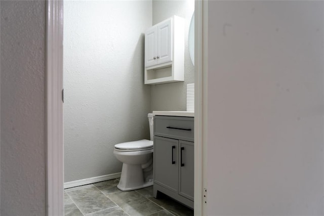 201 Lois Ave, Tuttle, OK 73089 - bathroom featuring toilet, vanity, and baseboards