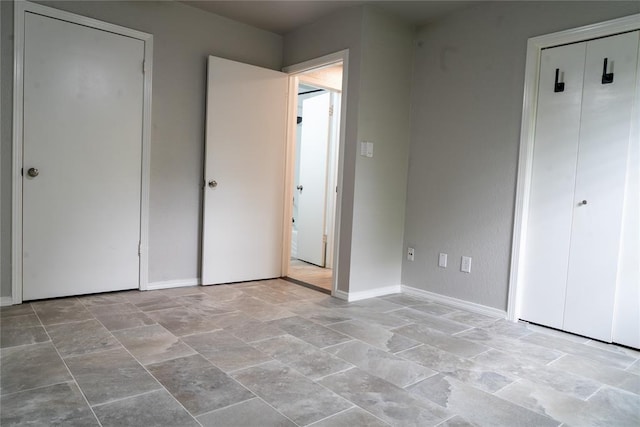 201 Lois Ave, Tuttle, OK 73089 - unfurnished bedroom with light stone finish floors and baseboards