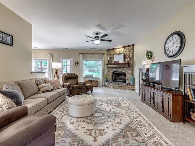 3570 Riverwood Ln, Edmond, OK 73034 - living room with carpet, a ceiling fan, and a fireplace