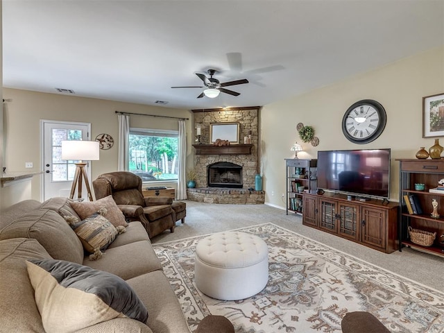 3570 Riverwood Ln, Edmond, OK 73034 - carpeted living area featuring a ceiling fan and a fireplace