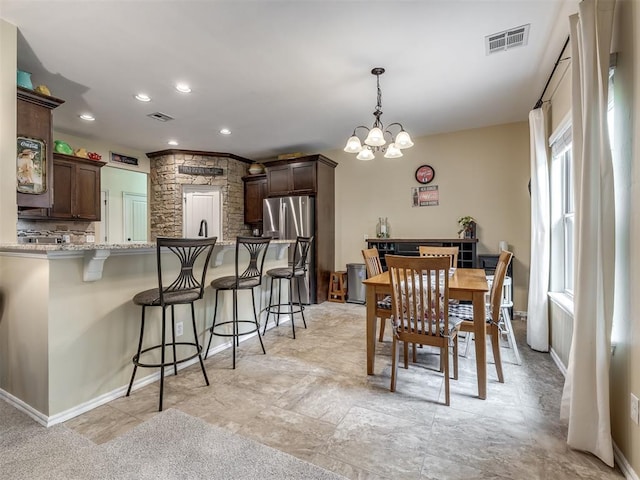 3570 Riverwood Ln, Edmond, OK 73034 - dining space with a chandelier, baseboards, and recessed lighting