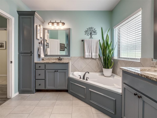 3570 Riverwood Ln, Edmond, OK 73034 - bathroom with a bath, two vanities, and tile patterned flooring