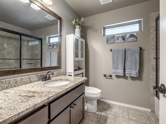 3570 Riverwood Ln, Edmond, OK 73034 - full bathroom featuring plenty of natural light, a shower with shower door, baseboards, and toilet